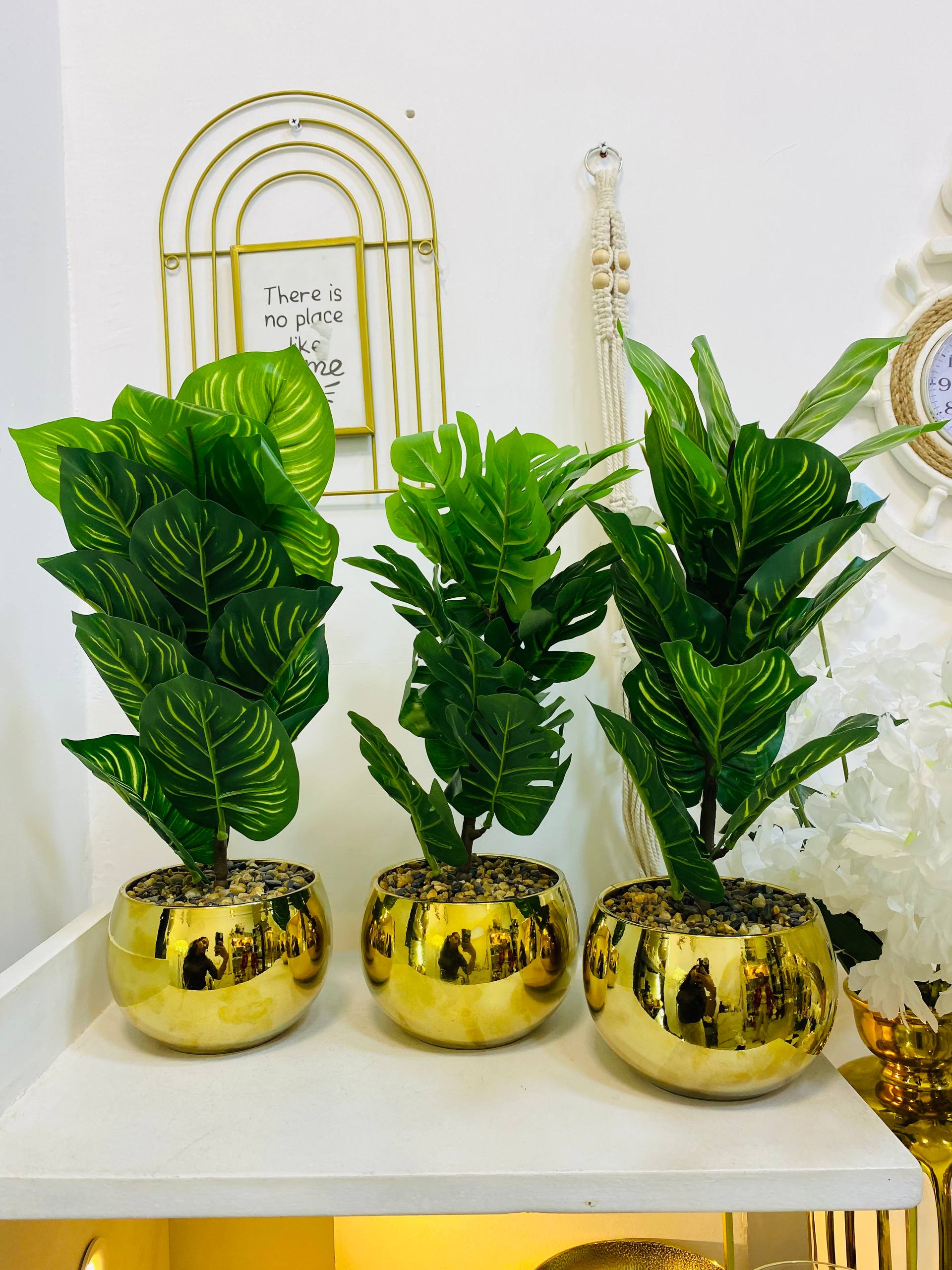 Ceramic golden pot and green leaf